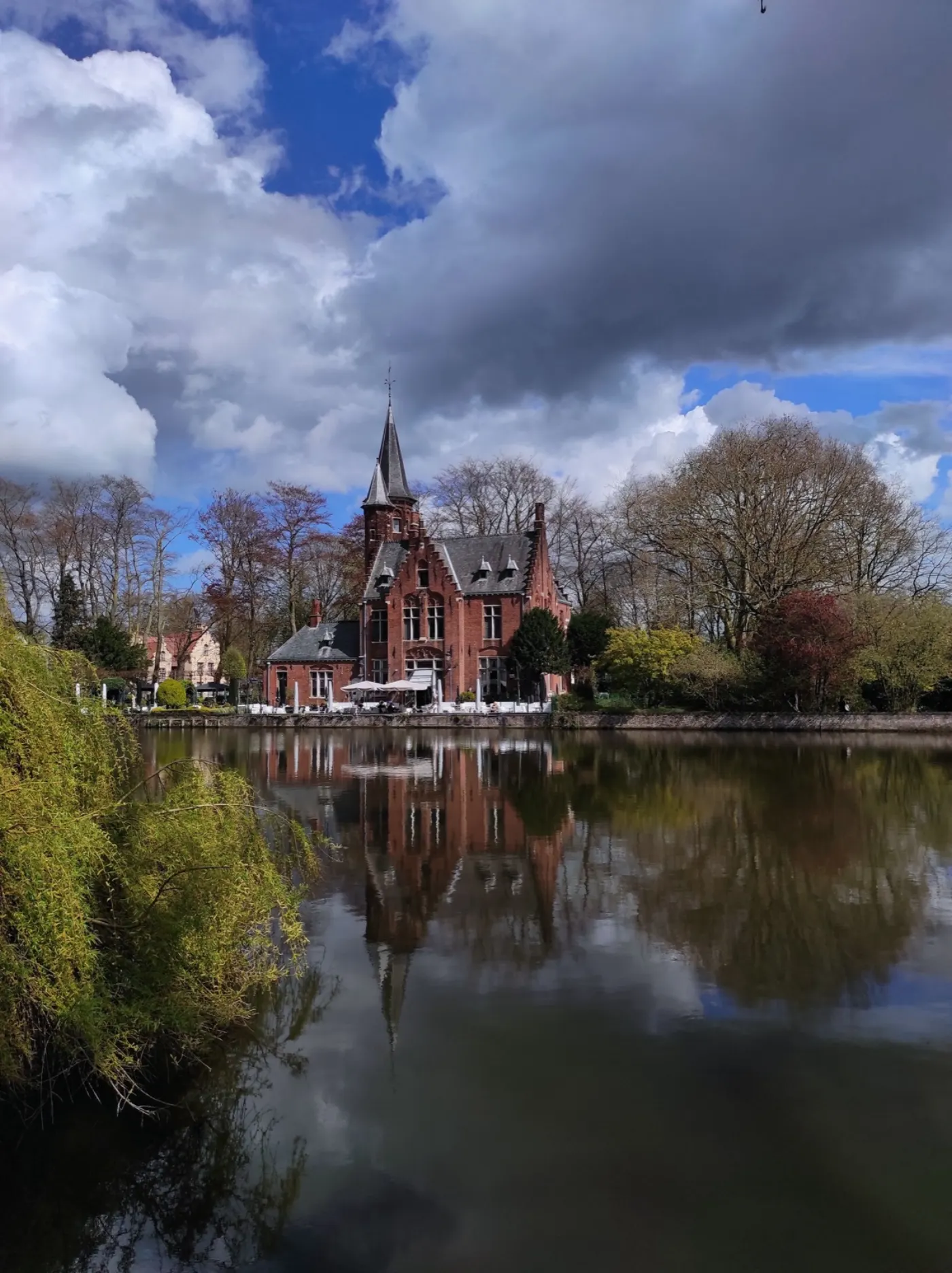 Minnewater lake, with the red-brick Kasteel Minnewater reflected in the water