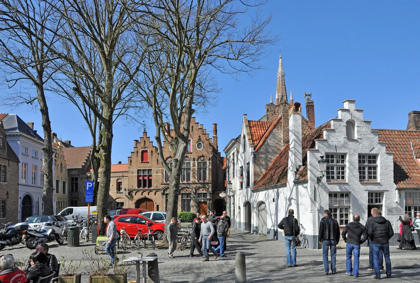 Walplein, a small square of trees and stepped gables, with people walking