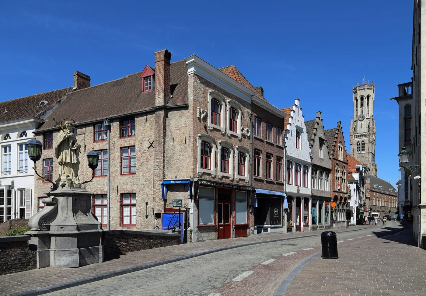 Wollestraat, a cobbled shopping street with the Belfry at the end
